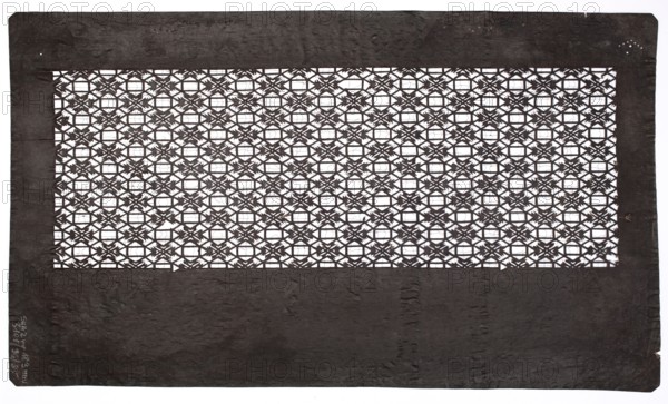 Katagami dyeing stencil with a pattern of interconnected octagons and squares shokkô moyô, ise-katagami stencil, chuban format; geometric pattern with a grid of figures and stylized four-petaled flower heads. Shokkô-type ornament borrowed from Chinese brocade patterns; 19th–20th century Meiji period, Japan. Stencil; height 40.0 cm, width 23.3 cm., A rectangular dark brown frame with a textured surface surrounds a central rectangular lattice cutout made of repeating geometric floral motifs, creating a grid of small open shapes that reveal a white background; the frame shows slight irregularities at the edges and a few small lighter spots, while the lattice is dark brown with crisp edges and contrasts sharply with the white visible through the openings.
