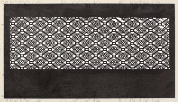 A katagami dyeing stencil for painting kimono, cut into a koshi check ornament with small floral rosettes woven into it, ise-katagami, Japanese art, Japanese culture, ca. 1850 Edo period, Japan, stencil; height 40.1 cm, width 24.3 cm., The image shows a rectangular pattern of repeating geometric cutouts set against a dark background, with a band of intricate latticework near the top and middle and a large darker area below. The lattice consists of a group of diamond-shaped motifs with diagonal striped elements and small floral-like shapes at their centers, creating a grid of connected octagonal and square openings. The predominant colors visible are black, white, and shades of gray, with the white areas forming the cutout pattern and the black and gray tones forming the surrounding background and textured lower field. The overall composition is framed by a narrow lighter border.