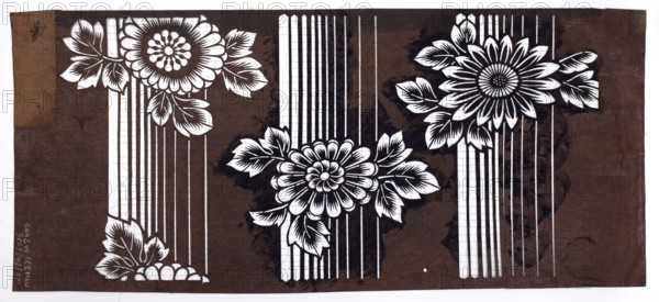 A katagami dyeing stencil cut into a pattern of chrysanthemum flowers against a background of vertical groups of stripes of various widths. Pattern cut on the pattern: three parallel horizontal stripes of chrysanthemum heads with leaves. Stencil, Japan, 19th/20th century Meiji period, 1868–1912. Height 40.2 cm, width 17.8 cm; ise-katagami., A horizontal rectangular artwork shows a dark brown background with a pattern of three large stylized flowers and surrounding leaves rendered in white cutout shapes, connected by vertical white stripes of varying thickness; the flowers have layered petals and detailed leaf veins, and there are darker brown irregular stains and smudges on the background, with the left edge showing a lighter brown rectangular patch and a small darker mark, while the composition overall contrasts white floral elements against brown tones.