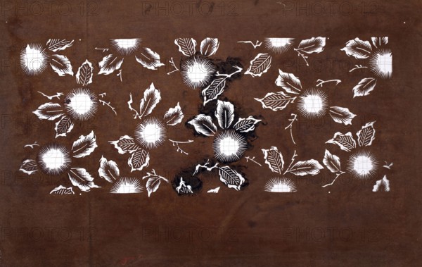 Katagami dyeing stencil cut into a pattern composed of flowers and leaves; katagami stencil, plant ornament; Japanese art; 19th/20th century Meiji period, 1868–1912; Japan; stencil; height 41.0 cm, width 25.7 cm, A brown background fills the image with a horizontal band of white floral stencil shapes across the center; the white shapes include a group of circular sunburst-like flowers with radiating lines and surrounding stylized leaves and small curved twig-like accents. The central area shows a few darker brown and nearly black smudges overlapping some white shapes. The leaves are rendered with white outlines and internal striped patterns, and the flowers have white centers with fine radial strokes. The overall palette is brown, white, and touches of dark brown to black.