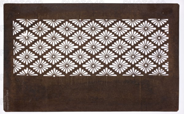 Katagami dyeing stencil; pattern of rhomboidal floral rosettes hanabishi; maker, Meiji period 19th/20th century, 1868–1912, Japan; ise-katagami stencil; geometric ornament; height 40.8 cm, width 25.2 cm., A rectangular dark brown sheet with a central band of repeated cutout floral shapes showing the white background through petal-like openings; the floral pattern forms diagonal rows of rounded petals around small circular centers, and a plain dark brown border surrounds the patterned band.