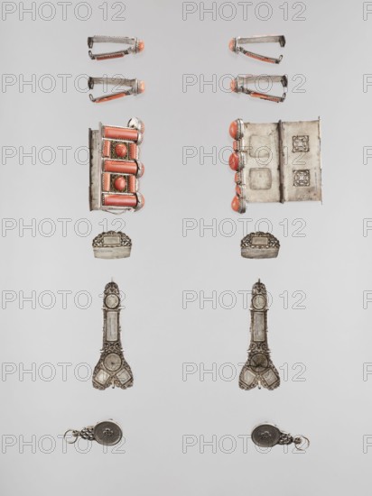 Set of braid ornaments, braid ornaments, artistic crafts, Mongolian art, jewelry, braids, ornaments, women's ornaments, 19th–20th century, Mongolia, height 3 cm, width 7.8 cm, A symmetrical arrangement of small metallic objects laid out on a neutral light gray background, each side mirroring the other. At the top are a few clip-like metal pieces with rounded coral-colored tips and silver-toned bodies. Below them are rectangular metal components with raised coral-colored cylindrical elements set into ornate silver frames, and opposite is a hinge-like rectangular piece with similar coral domes along one edge. Further down are a pair of small ornate silver caps with scalloped edges. Midway are two elongated ornate silver pieces with decorative cutwork and rounded ends, each showing wear and tarnish. Near the bottom are two small round silver fob-like pieces with looped attachments, both showing decorative motifs and a mix of bright silver and darker tarnished areas. The visible colors are...