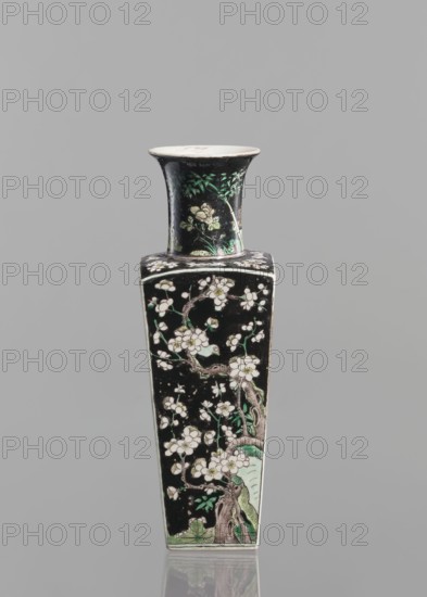 Pair of vases, Chinese, 18th century, Chinese ceramics, colored porcelain in famille noire palette, decorated with birds, plums, and floral motifs, vessel, height 22.5 cm., A tall, narrow vase with a flared rim and a square body decorated against a black background with a floral branch motif; the design shows pale blossoms and buds on twisting brown branches with green leaves and pale green accents at the base and on the neck, and the rim interior appears off-white while the exterior surface is predominantly black with touches of white, green, brown, and hints of pale yellow.