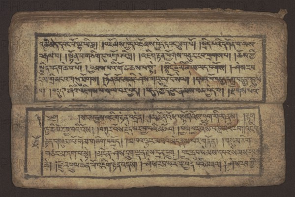 Buddhist text - Commentary on the praise of the names of Manjushri by Ga Rabjampa Kunga Yeshe Tib. 'phags pa 'jam dpal gyi mtshan yang dag par brjod pa zhugs so, unknown creator role, author. Buddhist art, Tibetan, graphic prints. Book in Tibetan pecha style, xylographic print in student script dbu can. 26 folios, recto page numbering, first verso, 2 pages missing. Buddhist commentary on the prayer of praise in honor of the names of the bodhisattva Manjushri Tib. 'jam dpal dbyang by Ga Rabjampa Kunga Yeshe Tib. sga rab 'byams pa kun dga' ye shes. Original text from the 15th century; this copy 19th century, Tibet. Graphics, width 24.6 cm, height 8.0 cm., A worn rectangular manuscript page lies open showing two horizontal panels each framed with a dark border; the paper has a yellowed, beige tone with areas of brownish aging and darker stains, and there are visible smudges and spots in brown and gray. Each panel contains dense dark brown to black ink strokes arranged in horizontal lines,...