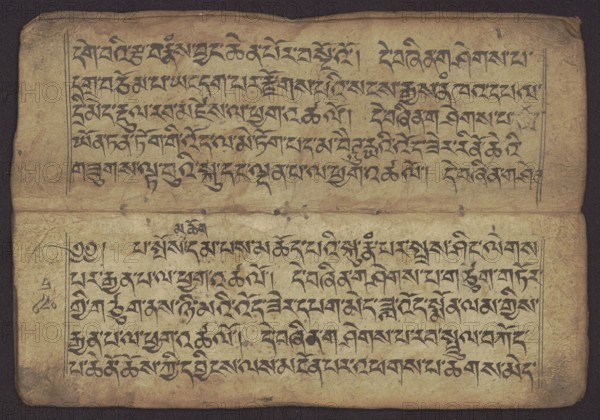 Buddhist manuscript - Penitential Text Tib. sDig bshags gser gyi zhes bya ba bzhugs+o, unknown author/scribe student copyist, Tibetan Buddhist art, Himalayan culture, book in Tibetan pecha style, manuscript in student's script. Leaf numbering 2–22 verso, first recto, last two unnumbered. Handwritten notes folio 24 recto and verso. 19th century, Tibet. Manuscript; width 24.0 cm, height 8.1 cm., An aged rectangular sheet with a dark brown background border contains a worn tan page divided into two horizontal sections, each filled with rows of dark black calligraphic strokes; the paper shows creases, small stains, and slightly darker edges, with vertical ruling lines near the left and right margins, small ink marks and smudges scattered across the surface, and a few tiny holes or pits visible along the central fold.