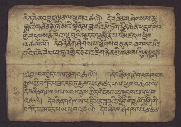 Buddhist Manuscript - Penitential Text Tib. sDig bshags gser gyi zhes bya ba bzhugs+o, unknown creator role/classification of the creator, scribe-copyist author, Tibetan Buddhist art, Himalayan culture, Book in Tibetan pecha style, manuscript in student's script. Leaf numbering 2-22 verso, first recto, last two unnumbered. Handwritten notes folio 24 recto and verso. 19th century, Tibet, manuscript, width 24.0 cm, height 8.1 cm., A worn rectangular sheet with an aged beige surface and darker brown edges, showing a horizontal fold across the middle and creases and small stains throughout; a group of dark black brushlike marks arranged in horizontal lines fills the upper half and lower half within lightly drawn rectangular margins; the background shows subtle variations of tan and yellowed brown, with a darker brown border surrounding the sheet.