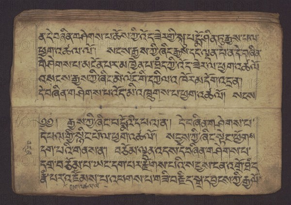 Buddhist manuscript — Penitential Text Tib. sDig bshags gser gyi zhes bya ba bzhugs+o, unknown creator scribe-copyist, Tibetan Buddhist art, Himalayan culture. Book in Tibetan pecha style, manuscript in student's script. Leaf numbering 2–22 verso, first recto, last two unnumbered. Handwritten notes folio 24 recto and verso. 19th century, Tibet. Manuscript. Width 24.0 cm, height 8.1 cm., A horizontal image of an old, open manuscript page showing two facing leaves with dense handwritten dark ink script arranged in horizontal lines separated by a visible fold; the paper appears aged and worn with uneven edges, small creases, and a few tiny holes along the fold. The ink is predominantly black or very dark brown against a yellowed, tan to beige paper background, with some areas of darker discoloration near the edges. A narrow dark border surrounds the manuscript, and there are subtle brownish stains and smudges across the surface. The top edge shows layered, slightly warped paper and the lo...