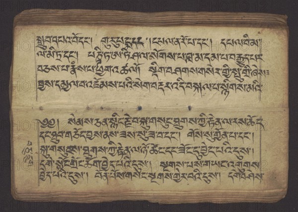 Buddhist Manuscript - Penitential Text Tib. sDig bshags gser gyi zhes bya ba bzhugs+o, unknown author/scribe, Tibetan Buddhist art, Himalayan culture, Book in Tibetan pecha style, manuscript in student's script. Leaf numbering 2–22 verso, first recto, last two unnumbered. Handwritten notes folio 24 recto and verso. 19th century, Tibet, manuscript, width 24.0 cm, height 8.1 cm, A horizontal rectangular sheet with aged beige paper showing a group of dark black calligraphic lines arranged in two horizontal blocks separated by a fold, with a few vertical ruling lines at the edges; the top and bottom margins show stacked edges of additional sheets and a dark textured border background; the paper has small dark spots and stains and a few tiny holes along the fold; visible colors include beige, black, dark brown, and hints of muted yellow.