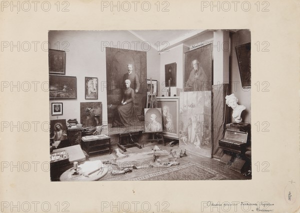 The Last Studio of Pantaleon Szyndler in Warsaw Painting studio of Pantaleon Szyndler 1846–1905 in Aleje Jerozolimskie in Warsaw, Bogacki, Stanislaw fl. ca 1890–ca 1935 photographer/author, painting, Polish painting, Szyndler, Pantaleon 1846–1905, interiors, Imperial Society for Rational Hunting, Warsaw Cyclists' Society 1886–, artists' studios, painters' studios, Szyndler, Pantaleon 1846–1905 - reproduction, photography, Norwid, Cyprian Kamil 1821–1883 - iconography, print glued across the entire surface onto cardboard, ca. 1902–1905, Warsaw, photography, nature photography, photographic print: height 17.4 cm, width 23.4 cm; cardboard: height 24.6 cm, width 34.9 cm; passe-partout: height 32.0 cm, width 43.0 cm, A room filled with framed paintings leaning against walls and on easels, including a large portrait of a seated woman with a standing man behind her, a portrait of an older bearded man, and several other figurative and religious-themed images; a white sculpted bust rests atop a...