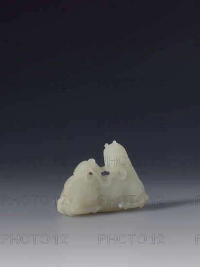 Paperweight — horse and monkey; maker, subject: horse and monkeys; materials/implements for painting; culture: Chinese; style/period: Qing 1644–1911, 18th–19th century; function: decoration; dimensions: height 6.6 cm, width 4.3 cm., A small smooth pale object with a creamy white color sits on a flat surface, carved into the shape of two rounded animals positioned close together with flowing curved lines and subtle raised details; the background is a gradient of dark charcoal to deep gray fading toward the bottom, and the surface beneath the object is a lighter gray that reflects a faint soft shadow.