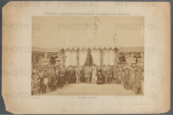 Industrial and Agricultural Exhibition at Ujazdowski Square in Warsaw in 1874. A group of people in front of the Count's pavilion. Ludwik Krasinski during the opening on September 15. Photograph by Maksymilian Fajans 1825–1890. Subjects: exhibition pavilions, Ujazdów Warsaw, industrial and economic exhibitions; persons depicted include Krasinski, Ludwik 1833–1895 and Kotzebue, Pawel 1801–1884. Print glued to cardboard with the entire surface. Date: 15/09/1874, place: Warsaw. Photograph from nature; photographic print: height 26.9 cm, width 17.9 cm; cardboard: height 30.5 cm, width 20.7 cm; passe-partout: height 43.0 cm, width 32.0 cm., A sepia-toned photograph mounted on a faded beige board shows a group of people standing in front of a large decorative tent with scalloped trim and draped curtains; the tent has flags on top and decorative foliage at the entrance. The assembled crowd includes men in dark coats and top hats, a few men in uniforms with visible decorative details, and a fe...