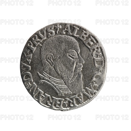 Trojak, Schilling, Maciej mintmaster / publisher; Decjusz, Jost Ludwik fl. 1528–1535 co-creator, mint manager. Obverse: male bust in armour in profile to right; short hair, long beard with sideburns; rim inscription beginning with a trefoil: -ALBER D G MAR BRAN DVX PRVS; pearl border, plant motifs between words. Reverse: six-line inscription in pearl border: -III-/.GROSS:AR:/.TRIPLEX./.ALBER:DVC./.PRVSSIE./-I544-; denomination and date between trefoil marks. 1544. Ducal Prussia 1525–1701, Königsberg mint. Coin; diameter 21.0 mm, weight 2.53 g, axis 45°., A round metallic coin with a raised profile of a bearded man facing right, showing a textured hair and beard, a visible ear, eye, nose, and lips; the man wears layered collar details. The coin surface is silver-gray with darker gray recesses and lighter highlights on raised areas, showing wear and fine scratches. A raised rim encircles the portrait and a ring of raised decorative elements follows the rim. The background behind the coin...