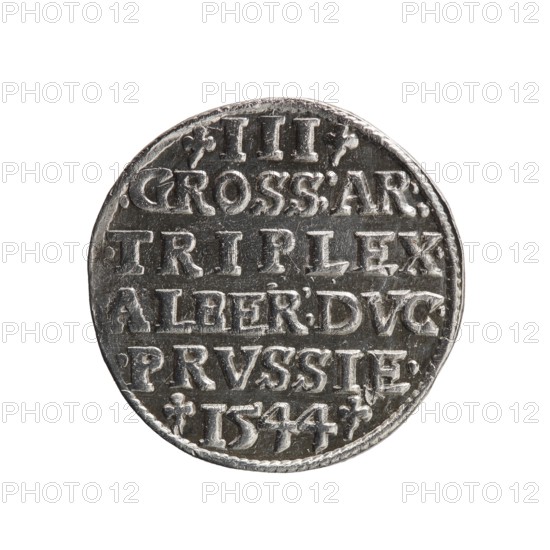 Trojak; Schilling, Maciej mintmaster; Decjusz, Jost Ludwik fl. 1528–1535 co-creator. Obverse: male bust in armour in profile to right; short hair, long pointed beard with sideburns; rim inscription beginning with a trefoil: -ALBER DG MAR BRAN DVX PRVS; pearl border, plant motifs between words. Reverse: six-line inscription in pearl border: -III-/.GROSS:AR:/.TRIPLEX./.ALBER:DVC./.PRVSSIE./-1544-; denomination and date between trefoil marks. 1544. Ducal Prussia 1525–1701, Königsberg mint. Coin; diameter 21.2 mm; weight 2.71 g; axis 315°., A circular metallic object with a worn, textured surface appears centered against a white background; it shows raised, blocky carved shapes arranged in horizontal rows across its face, with small decorative marks near the edges and a braided-looking rim; visible colors include silver, dark gray, and hints of black in recessed areas.