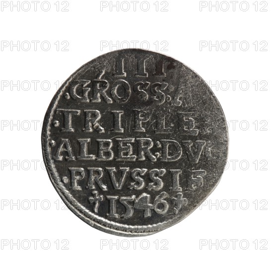 Trojak, Schilling, Maciej mintmaster; co-creator. Obverse: male bust in armour in profile turned right; short hair, long pointed beard with sideburns; rim inscription beginning with a trefoil: -ALBER DGMAR BRAN .VX PRVSS, pearl border, plant motifs between words. Reverse: in the pearl border an inscription in six lines: -III-/.GROSS:AR/.TRIPLEX./.ALBER:DVC./.PRVSSIE./-I546-; denomination and date between trefoil marks. 1546. Ducal Prussia 1525–1701, Königsberg mint. Coin; diameter 21.2 mm, weight 2.46 g, axis 60°., A round metallic coin photographed against a white background, showing a worn textured surface with raised and recessed areas and decorative depressions; the coin appears primarily dark gray with lighter silvery highlights on the raised edges and lettering, and faint darker scratches and scuffs across its face; the rim is slightly irregular and the overall shape is circular but not perfectly smooth.