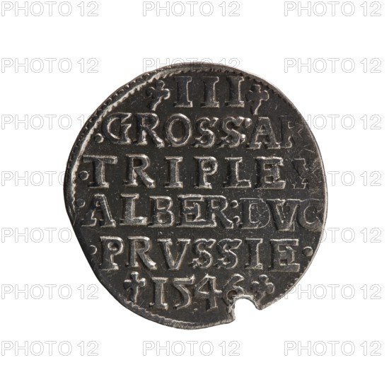 Trojak, Schilling, Maciej mintmaster; co-creator. Albrecht Hohenzollern Prince of Prussia; 1490–1568 — iconography: trefoils, male busts in armour. Obverse: male bust in armour in profile turned right; short hair, long pointed beard with sideburns. In the rim an inscription beginning with a trefoil: -ALBER DG MAR BRAN DVX PRVSS; pearl border, plant motifs between the words. Reverse: in the pearl border an inscription in six lines: -III-/.GROSS:AR:/.TRIPLEX./.ALBER:DVC./.PRVSSIE./-I546-; the denomination and date are between trefoil marks. 1546. Ducal Prussia 1525–1701, Königsberg mint. Coin; diameter 21.1 mm; weight 2.54 g; axis 220°., A round metal coin with a dark gray surface and lighter silver highlights, showing raised lettering and decorative marks across its face, with a small semi-circular notch missing at the lower edge and a lightly textured rim.