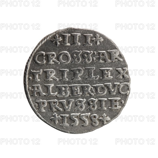 trojak, Albrecht Hohenzollern Prince of Prussia; 1490–1568 - iconography: towers, male busts in armor. Obverse: male bust in armor in profile turned to the right; short hair, long pointed beard with sideburns. In the rim an inscription beginning with a tower-ALBER.D.G.MAR.BRAN.DVX.PRVSS, pearl border. Reverse: in the pearl border an inscription in six lines: +III+/GROSS:AR./.TRIPLEX/.ALBER:DVC./.PRVSSIE./+I558+. Denomination and date between lilac crosses, 1558. Ducal Prussia 1525–1701, Königsberg; coin. Diameter 21.0 mm, weight 2.45 g, axis 200°., A round metallic object with a worn silver-gray surface fills the frame against a white background; the object has an irregular edge and a textured face with raised, blocky shapes arranged in horizontal bands, showing indentations and scratches; there is a small decorative star-like shape near the top and bottom, and the object shows darker gray recesses contrasting with lighter silvery highlights on the raised areas.