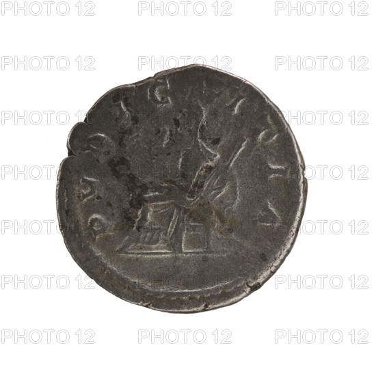Denarius, Elagabalus reigned 218–222. Obverse: IVLIA MAESA AVG — Draped bust of Julia Maesa facing right, pearl rim. Reverse: PVDICITIA — Veiled Pudicitia seated on a throne facing left, raising the hem of her veil with her right hand and holding a scepter in her left, pearl rim. Date: 218–223. Roman Empire. Mint: Rome. Coin; diameter ca. 17.5–18.0 mm; weight 3.30 g., A round, worn coin with a dark gray metallic surface showing areas of lighter gray where edges and raised details are rubbed, featuring an embossed central design that appears textured and slightly raised above the field, with irregularities and small pits across its face and a scalloped edge on one side.
