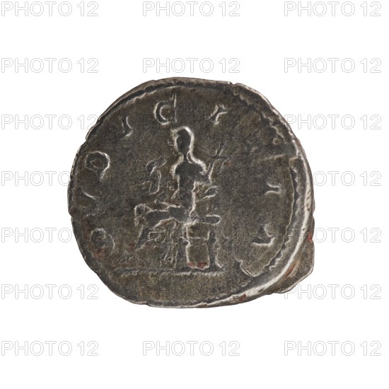 Denarius, Elagabalus 204–222; Roman emperor 218–222. Obverse: IVLIA MAESA AVG — draped bust of Julia Maesa facing right, pearl rim. Reverse: PVDICITIA — veiled Pudicitia seated on a throne facing left, raising the hem of her veil with her right hand and holding a scepter in her left, pearl rim. Inscription dates c. 218–223. Roman Empire; mint: Rome. Coin; diameter ~17.5–18.5 mm; weight 3.30 g. Julia Maesa ca. 160–224; Augusta 218–224. Iconography: Julia Maesa; Pudicitia personification, seated Pudicitia., A round, worn metal coin with a dark gray surface and areas of lighter gray wear, showing a raised central figure seated on a structure; the figure and surrounding shapes are rendered in low relief and appear weathered. The coin edge is irregular with small chips and a thin band of lighter metal along parts of the rim. There are faint impressions of decorative elements around the central figure and subtle reddish-brown spots of discoloration on parts of the surface. The background of ...
