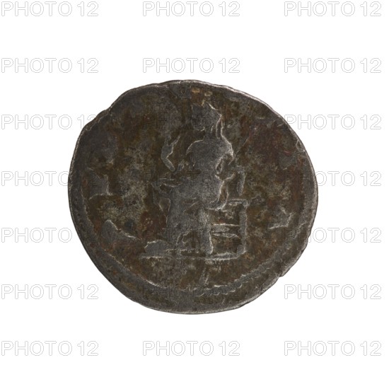 Denarius, Elagabalus reign 218–222 CE. Obverse: IVLIAMAESAAVG — Draped bust of Julia Maesa facing right, pearl border. Reverse: PVDICITIA — Veiled Pudicitia seated on a throne facing left, raising the hem of her veil with her right hand and holding a scepter in her left, pearl border. Roman Empire, struck in Rome, 218–223 CE. Coin; diameter ~17.5–19.0 mm, weight 2.45 g., A round, worn coin with an uneven, slightly irregular edge showing a raised central design of a seated figure facing right. The surface shows mottled areas of dark gray, brown, and hints of dull green and rust, with lighter gray highlights on the raised parts. The figure and surrounding details have a textured, weathered appearance with patches of smoother wear, and the coin sits against a plain white background.