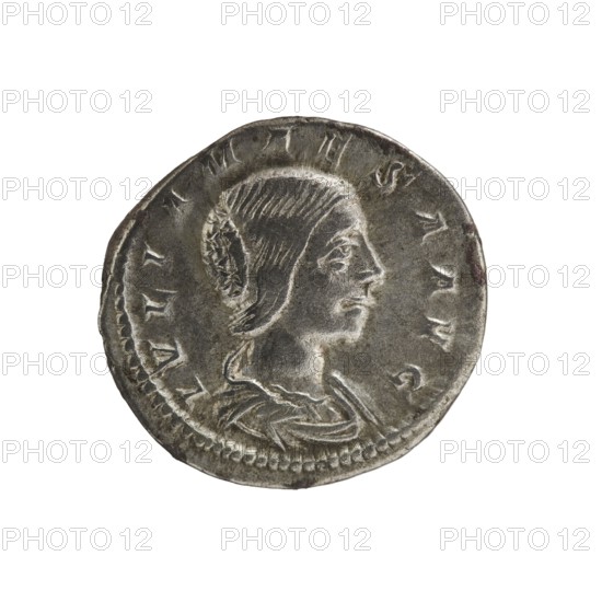 Denarius, Elagabalus reigned 218–222. Obverse: IVLIAMAESAAVG — Draped bust of Julia Maesa facing right, pearl border. Reverse: PVDICITIA — Veiled Pudicitia sits on a throne facing left, raising the hem of her veil with her right hand, holding a scepter in her left, pearl border. Date: 218–223. Place of origin: Rome. Medium: coin. Diameter: 18.5 mm. Weight: 3.05 g., A round metallic coin with a worn silver-gray surface showing a raised profile of a person facing right, with visible hair details and a decorative element at the back of the head, surrounded by a slightly raised rim and a ring of small bead-like indentations near the edge; the coin shows areas of darker gray and some subtle brownish tarnish, with highlights of lighter silver on the raised features.