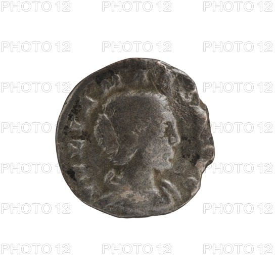 Denarius of Elagabalus reigned 218–222. Obverse: IVLIA MAESA AVG — Draped bust of Julia Maesa facing right; pearl border. Reverse: PVDIC ITIA — Veiled Pudicitia seated on a throne facing left, raising the hem of her veil with her right hand and holding a scepter in her left; pearl border. Date: 218–223. Roman Empire. Rome. Coin; diameter 16.5–17.0 mm; weight 2.30 g., A worn round metal object with an irregular edge appears against a white background, showing a raised profile of a head in relief. The surface has a dark metallic appearance with areas of lighter and darker gray, plus hints of brownish patina and small patches of black discoloration. The head is oriented to the right and surrounded by a shallow raised rim, with textured areas suggesting wear and abrasion across the object.