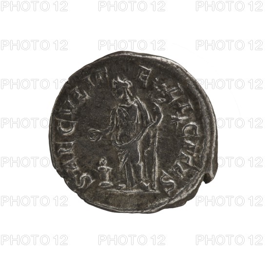 Denarius, Elagabalus Roman emperor 218–222. Obverse: IVLIA MAESA AVG — Draped bust of Julia Maesa facing right, pearl rim. Reverse: SAECVLI FELICITAS — Felicitas standing left, holding a patera above a burning altar in her right hand and a long caduceus in her left; star in right field, pearl rim. Date: 218–223. Place of origin: Rome. Medium: coin. Diameter: 18.0–18.5 mm. Weight: 3.40 g., A round dark gray coin with a slightly irregular edge is shown against a white background; the coin surface has a worn, metallic texture and lighter gray highlights on raised areas. In the center of the coin there is a low-relief figure of a standing person draped in robes, holding an object in one hand and a long staff or spear in the other, with a small raised pedestal or object near their feet. Around the rim of the coin are raised decorative markings following the circular edge. The visible colors are dark gray, lighter gray highlights, and white in the background.