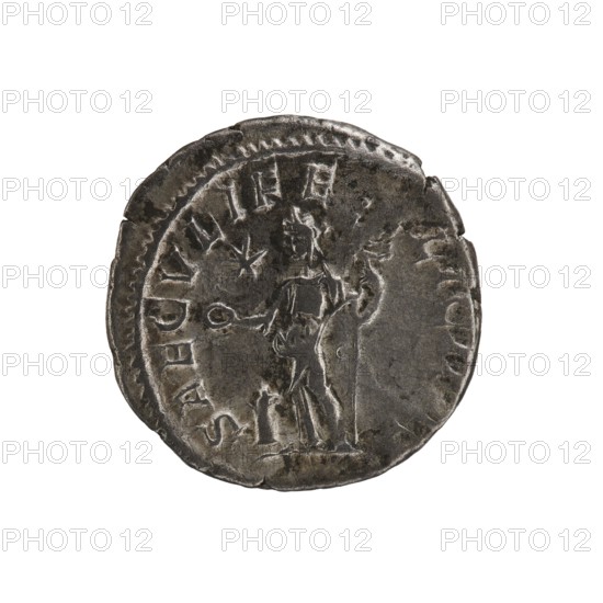 Denarius, Elagabalus 204–222; Roman emperor 218–222. Obverse inscription: IVLIAMAESAAVG. Draped bust of Julia Maesa facing right, pearl rim. Reverse inscription: SAECVLIFE LICITAS. Felicitas stands facing left, holding a patera above a burning altar in her right hand and a long caduceus in her left; star in right field, pearl rim. Date: 218–223. Place of origin: Rome. Coin; diameter 18.5–19.5 mm; weight 2.80 g., A round metallic object with a worn, uneven edge showing a patina of dark gray and lighter silver tones, featuring a raised central figure of a standing person holding a staff in one hand and a small round object in the other, with the figure rendered in low relief and surrounded by a circular border and a few decorative marks, all set against a plain white background.
