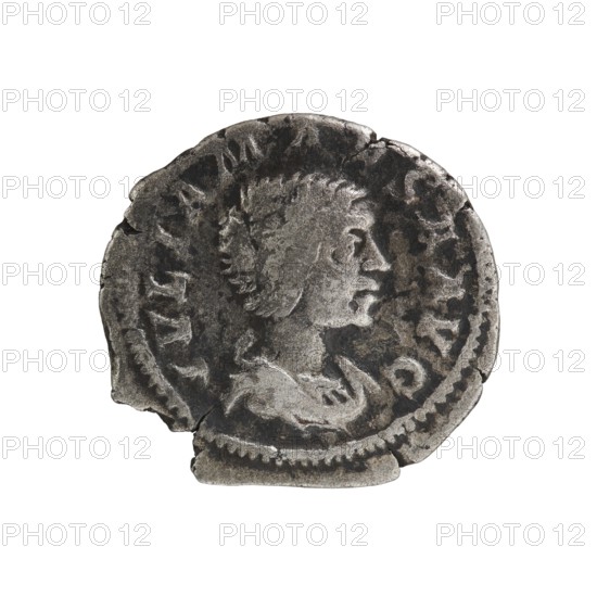 Denarius, Elagabalus Roman emperor 218–222. Obverse: Draped bust of Julia Maesa facing right, IVLIAMAESAAVG, pearl rim. Reverse: Felicitas standing facing left; in her right hand a patera held above a burning altar, in her left hand a long caduceus; star in right field, SAECVLIFE LICITAS, pearl rim. Date: 218–223. Coin; diameter 18.0–18.5 mm; weight 2.72 g., A worn circular metal object with a raised profile of a person facing right in the center, showing textured hair and facial features, surrounded by a patterned border and irregular edges with chips and cracks; visible colors include shades of gray, dark gray, and silver.