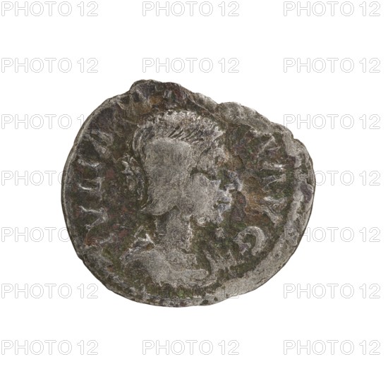 Denarius, Elagabalus 204–222; Roman emperor 218–222. Obverse: IVLIA MAESA AVG — Draped bust of Julia Maesa facing right, pearl rim. Reverse: SAECVLI FELICITAS — Felicitas stands facing left, holding a patera above a burning altar in her right hand and a long caduceus in her left, pearl rim. 218–223, Rome. Roman Empire 27 BC–476. Coin; diameter 17.0–19.0 mm; weight 2.12 g., A worn round metallic object with an irregular edge showing a raised profile of a person in the center, surrounded by textured background details; the surface shows areas of dark gray, light gray, brown, greenish patina, and hints of reddish tones, with uneven wear and pitted spots across the face of the object.