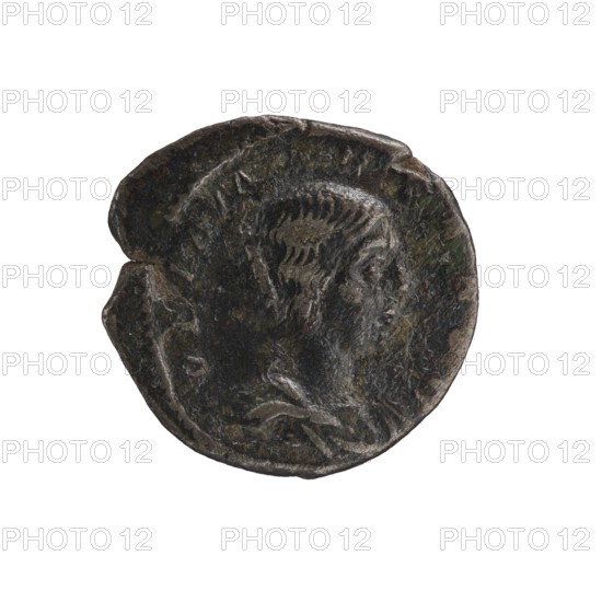 Denarius, Elagabalus Roman emperor 218–222. Obverse: Draped bust of Julia Maesa facing right, pearl border; inscription IVLIA MAESA AVG. Reverse: Felicitas standing left; in her right hand a patera held above a burning altar, in her left a long caduceus; star in right field, pearl border; inscription SAECVLI FELICITAS. Rome; 218–223. Coin; diameter ~18.0–18.5 mm; weight 2.55 g., A round metallic object with an irregular edge showing a raised profile of a person facing right, textured hair and facial features, and a worn surface with patina; colors visible include dark gray, black, brown, green, and hints of lighter gray.