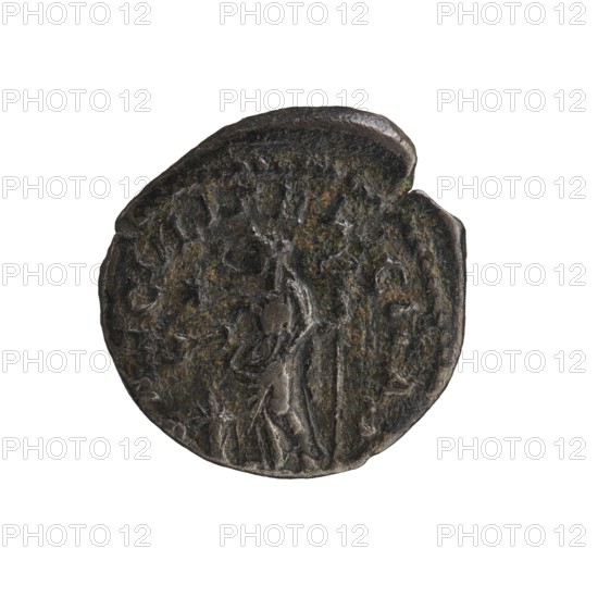Denarius, Elagabalus 204–222; Roman emperor 218–222. Obverse: IVLIA MAESA AVG — Draped bust of Julia Maesa facing right, pearl border. Reverse: SAECVLI FELICITAS — Felicitas standing left; in her right hand she holds a patera above a burning altar, in her left hand a long caduceus; star in right field, pearl border. Rome; 218–223. Coin denarius; diameter ~18.0–18.5 mm; weight 2.55 g., A round, worn dark metal coin with a rough, textured surface showing areas of brownish-green patina; the coin has irregular edges with a small chip on one side and a raised rim. Visible on the coin is a faint, low-relief human figure standing and facing sideways, with hints of drapery and an elongated object held upright beside them; surrounding the central image is a shallow, uneven border and traces of additional relief shapes. The colors visible are dark gray, black, brown, and green.