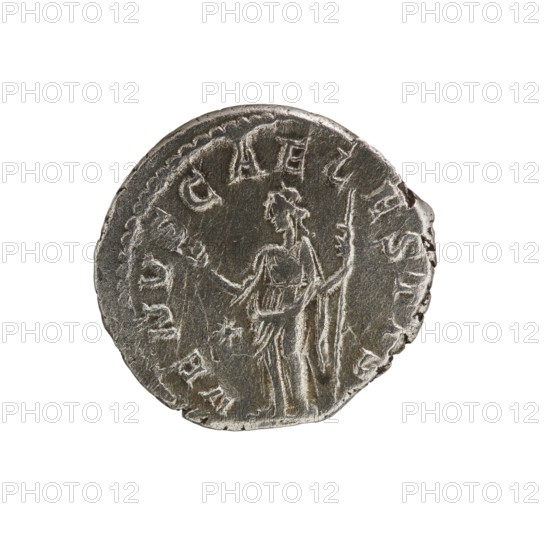 denarius, Elagabalus 204–222; Roman emperor 218–222 issuer, Julia Soaemias 180–222; Augusta 218–222, Roman Empire, Venus mythology - iconography. Obv.: IVLIA SOAEMIAS AVG — Draped bust of Julia Soaemias facing right, pearl rim. Rev.: VENVSCAE LESTIS — Venus standing left, holding an apple in her right hand and a scepter in her left, a star in the left field, pearl rim. 218–222, Rome; coin; diameter 19.0 mm; weight 3.15 g., A worn round metal coin with a textured surface and irregular edge showing a raised central figure of a standing person holding a long staff in one hand and an object in the other, surrounded by a border of raised, curved markings; the coin appears in shades of gray and silver with darker recessed areas and lighter worn highlights.