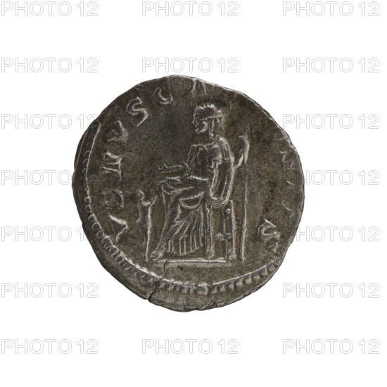 Denarius, Elagabalus 204–222; Roman emperor 218–222. Issuer: Julia Soaemias 180–222; Augusta 218–222. Roman Empire, Rome, 218–222. Obverse: IVLIA SOAEMIAS AVG — Draped bust of Julia Soaemias facing right, pearl border. Reverse: VENVS CAELESTIS — Venus seated on a throne facing left, holding an apple in her right hand and a scepter in her left; at her feet a child with outstretched arms, pearl border. Coin; diameter ~17.0–17.5 mm; weight 2.00 g., A circular metallic coin with a worn surface showing a seated figure in profile wearing draped clothing and a helmet, holding a curved object in one hand and resting the other hand near the lap, surrounded by a raised rim and faint decorative marks; the coin appears in shades of gray, silver, and dark gray with subtle darker spots and lighter highlights.