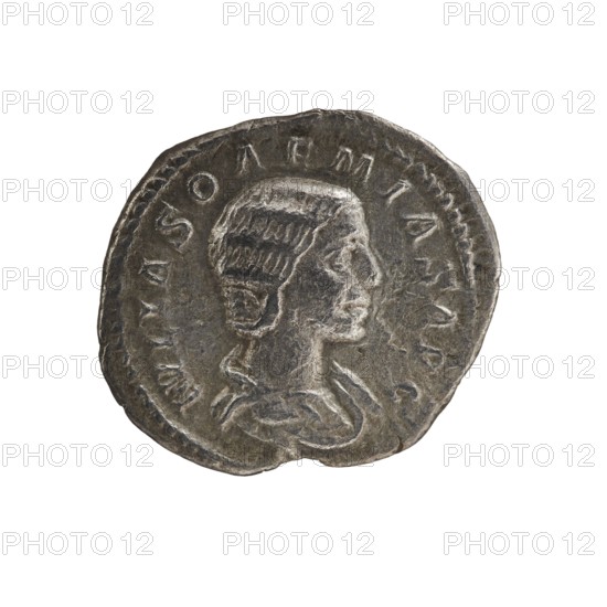 Denarius, Elagabalus reigned 218–222. Obverse: IVLIASOAEMIASAVG — Draped bust of Julia Soaemias facing right; pearl border. Reverse: VENVSCAELESTIS — Venus seated on a throne facing left, holding an apple in her right hand and a scepter in her left; at her feet a child with outstretched arms; pearl border. Issuer: Julia Soaemias Augusta, 218–222. Date: 218–222. Place of origin: Rome. Medium: silver coin. Diameter ~18–19 mm. Weight 2.70 g., A round metal object with a worn surface showing a raised profile of a person facing right, with detailed hair and facial features, and a textured border around the edge; the object appears in shades of gray and dark silver with areas of lighter silver highlights and subtle darker gray shadows.