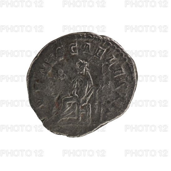 Denarius of Elagabalus reigned 218–222. Issued under Julia Soaemias Augusta 218–222. Obverse: IVLIASOAEMIASAVG — draped bust of Julia Soaemias facing right, pearl border. Reverse: VENVSCAELESTIS — Venus seated on a throne facing left, holding an apple in her right hand and a sceptre in her left; at her feet a child with outstretched arms, pearl border. Rome, 218–222. Coin; diameter 17.5–19.0 mm; weight 2.80 g., A round, worn coin with an uneven edge shown against a white background; the coin surface is dark gray with lighter gray highlights and a few small brownish spots, and it features a faint raised image of a seated human figure facing sideways along with worn raised markings around the rim.