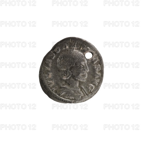 Denarius with a hole, Elagabalus reign 218–222, issued by Julia Soaemias Augusta 218–222. Obverse: IVLIASOAEMIASAVG — Draped bust of Julia Soaemias facing right, pearl border. Reverse: VENVSCAELESTIS — Venus seated on a throne facing left, holding an apple in her right hand and a scepter in her left; at her feet a child with outstretched arms, pearl border. Roman Empire, Rome, dated 218–222. Coin; diameter ~18.5–19.0 mm, weight 1.90 g., A single round metal object with a worn surface and a small hole near its edge, showing a raised profile of a person in relief; the object is primarily dark gray with lighter gray highlights and subtle brownish tones.