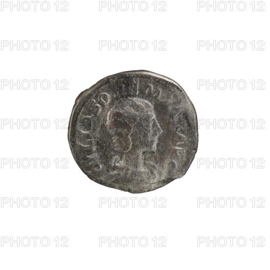 Denarius, Elagabalus 204–222; Roman emperor 218–222. Issuer: Julia Soaemias 180–222. Roman Empire, Rome, 218–222. Obverse: IVLIA SOAEMIAS AVG — draped bust of Julia Soaemias facing right, pearl border. Reverse: VENVS CAELESTIS — Venus seated on a throne facing left, holding an apple in her right hand and a scepter in her left; at her feet stands a child with outstretched arms, pearl border. Coin; diameter ~18–19 mm; weight 3.80 g., A worn circular metal object with an uneven edge is shown against a white background; the object has a textured surface in shades of gray and silver with darker gray and brownish areas, and a faint raised profile of a person facing to the right is visible at the center, surrounded by a ring of shallow raised marks around the perimeter.