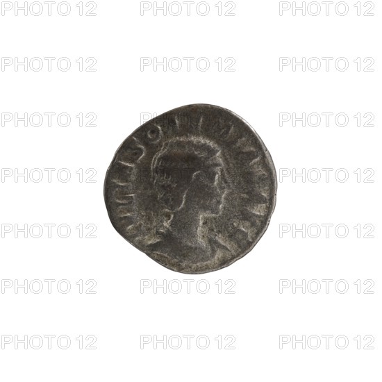 Denarius, Elagabalus reigned 218–222. Issued by Julia Soaemias Augusta, 218–222. Obverse: IVLIA SOAEMIAS AVG — draped bust of Julia Soaemias facing right; pearl border. Reverse: VENVS CAELESTIS — Venus standing left, holding an apple in her right hand and a scepter in her left; a star in the right field; pearl border. Rome, 218–222 CE. Coin; diameter 18.0 mm; weight 1.90 g., A round, worn coin with a raised profile of a person facing right in the center, showing textured hair and facial features in low relief; the coin surface appears dark gray with lighter gray highlights and some subtle brownish tones in spots; a faint raised rim and irregular edge are visible, and there is a ring of shallow, worn markings around the profile; the background is plain white.