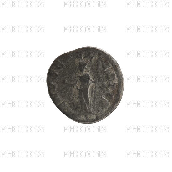 Denarius, Elagabalus 204–222; Roman emperor 218–222, issuer: Julia Soaemias 180–222; Augusta 218–222. Obverse: Draped bust of Julia Soaemias facing right, pearl border, inscription IVLIA SOAEMIAS AVG. Reverse: VENVS CAELESTIS — Venus standing left, holding an apple in her right hand and a scepter in her left, star in right field, pearl border. Rome, 218–222. Coin; diameter 18.0 mm, weight 1.90 g., A round, worn coin-like object with a rough, textured surface in dark gray and muted silver tones; the central area shows an indistinct raised relief that suggests curved shapes and shallow contours, and the edge is irregular and slightly uneven in color and thickness.