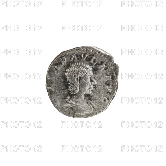 Denarius, Elagabalus Roman emperor 218–222 issuer, Julia Paula Roman empress 219–220. Obv.: IVLIAPAVLAAVG — Draped bust of Julia Paula facing right, pearl border. Rev.: CONCORDIA — Concordia seated left, holding a patera in her right hand, left elbow resting on the throne; star in left field, pearl border. 219–220 CE, Rome; coin; diameter ~18.0–18.5 mm; weight 2.77 g., A round metallic coin with a worn surface showing a raised profile of a person facing right, with short textured hair and visible facial features and neck, set against a plain white background; the coin appears silver-gray with darker gray areas in recessed parts and lighter gray highlights on raised areas, and the edge shows irregularities and slight chips.