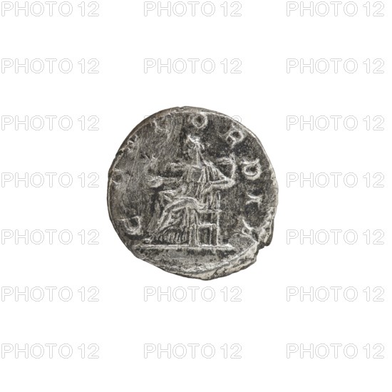 Denarius, Elagabalus Roman emperor 218–222 ; Julia Paula Roman empress 219–220. Obv.: IVLIAPAVLAAVG — Draped bust of Julia Paula facing right, pearl border. Rev.: CONCORDIA — Concordia seated left, holding a patera in her right hand, elbow of left arm resting on the throne; star in left field, pearl border. 219–220. Roman Empire; Rome. Coin. Diameter 18.0–18.5 mm; weight 2.77 g., A circular metallic object with a weathered, textured surface showing an engraved scene; the engraving depicts a seated human-like figure on a raised structure with another smaller raised element nearby, all rendered in shallow relief. The object appears uneven around the edge with small chips and wear. The visible colors are shades of gray, silver, and darker charcoal tones against a white background.