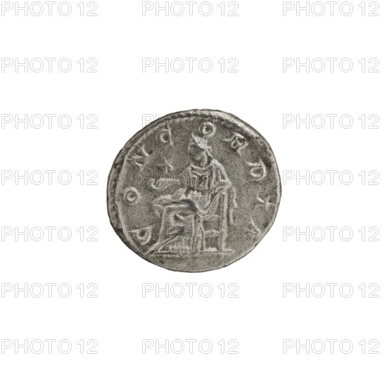 Denarius, Elagabalus Roman emperor 218–222 and Julia Paula Roman empress 219–220. Obverse: IVLIAPAVLAAVG — draped bust of Julia Paula facing right, pearl border. Reverse: CONCORDIA — Concordia seated left, holding a patera in her right hand, left elbow resting on the throne; star in left field, pearl border. Date: 219–220. Place of origin: Rome. Coin; diameter 18.5–19.0 mm; weight 3.00 g., A circular metallic object with a worn, textured surface showing an engraved seated figure holding a small object, surrounded by a ring of raised, worn markings; visible colors include shades of gray, silver, and a few darker gray tones.