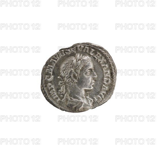 Denarius. Obverse: IMPCMAVRSEVALEXANDAVG — Bust of Alexander Severus with laurel wreath and paludamentum facing right; pearl rim. Reverse: PMTRP COSPP — Jupiter naked in a cloak stands facing left, holding a thunderbolt in his right hand and a long scepter in his left; pearl rim. Date: 222. Culture: Roman Empire 27 BC–476. Place of origin: Rome. Type: coin. Diameter: 17.0–19.0 mm. Weight: 2.51 g., A circular metallic object with a worn, textured surface showing a raised profile of a person facing right, their hair tied at the back and adorned with a laurel-like band; the relief includes facial features, a neck, and part of the shoulder, and the rim of the object is irregular and slightly dented. The visible colors are shades of silver and gray with darker gray patina in recessed areas.