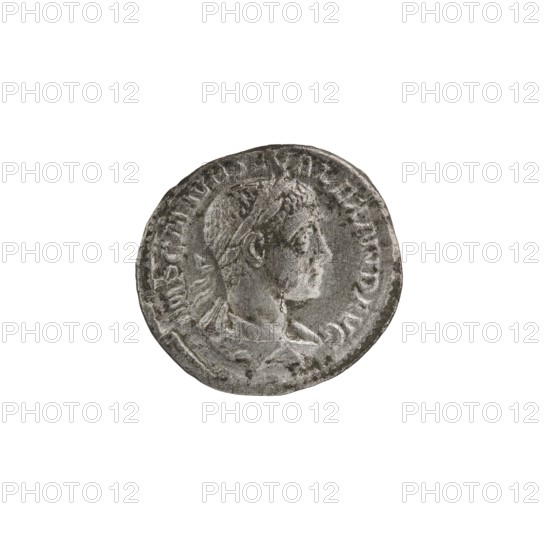 Denarius of Alexander Severus reign 222–235. Obverse: Bust of Alexander Severus with laurel wreath and paludamentum facing right; pearl border; inscription IMPCMAVRSEVALEXANDAVG. Reverse: Mars in military dress and helmet standing left, holding a branch in his right hand and leaning his left against a standing spear; pearl border; inscription PMTRP C OSPP. Coin dated 222, struck in Rome. Roman coin; diameter ~18–19 mm; weight 2.41 g., A round metallic coin with a worn relief portrait of a person in profile facing right, showing facial features, hair, and a laurel-like headpiece; the coin surface is textured with signs of wear and raised decorative edges, and the visible colors are shades of gray, silver, and dark gray.