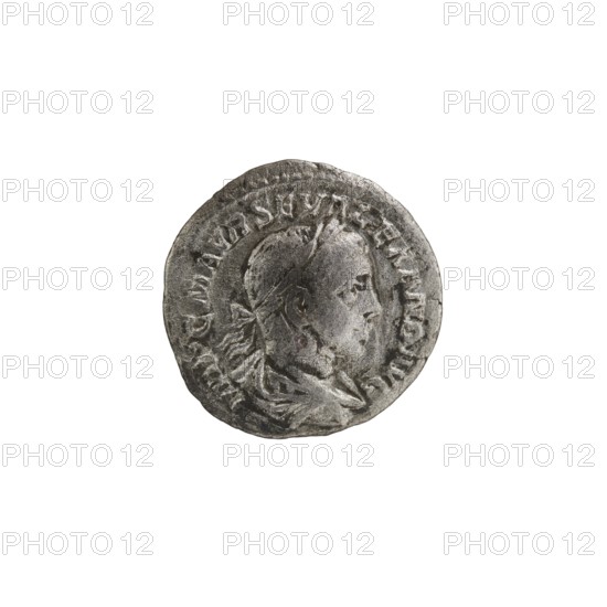 Denarius, Alexander Severus 208–235; Roman emperor 222–235. Obverse: Bust of Alexander Severus with laurel wreath and paludamentum facing right; legend IMPCMAVRSEVALEXANDAVG; pearl border. Reverse: Mars in military dress and helmet standing left, holding a branch in his right hand and leaning his left against a standing spear; legend PMTR P C OSPP; pearl border. Roman Empire, 222. Coin; diameter 19.5 mm, weight 2.22 g., A round metallic coin viewed from above showing a raised profile of a person's head facing right, with visible facial features, hair and a headband, surrounded by a raised border and decorative raised elements; the coin surface appears worn and textured with dents and scratches. The colors visible are shades of gray, silver and darker gray tones.