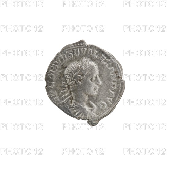 Denarius of Alexander Severus reigned 222–235. Obverse: Bust of Alexander Severus in laurel wreath, armor and paludamentum facing right; legend IMPCMAVRSEVALEXANDAVG; pearl border. Reverse: Mars in military dress and helmet standing left, holding a branch in his right hand and resting his left on a standing spear; legend MARTIPACIFERO; pearl border. Attribution: Roman Empire, Rome; ca. 222–228. Coin; diameter ~18.5–20.0 mm; weight 2.85 g., A worn circular coin with an embossed side-profile of a person facing right, showing facial features, hair styled back and a visible ear, surrounded by a raised border with decorative markings; the coin appears metallic with shades of gray and silver and darker gray patina in crevices, with a few irregular edges and small chips along its rim, set against a plain white background.