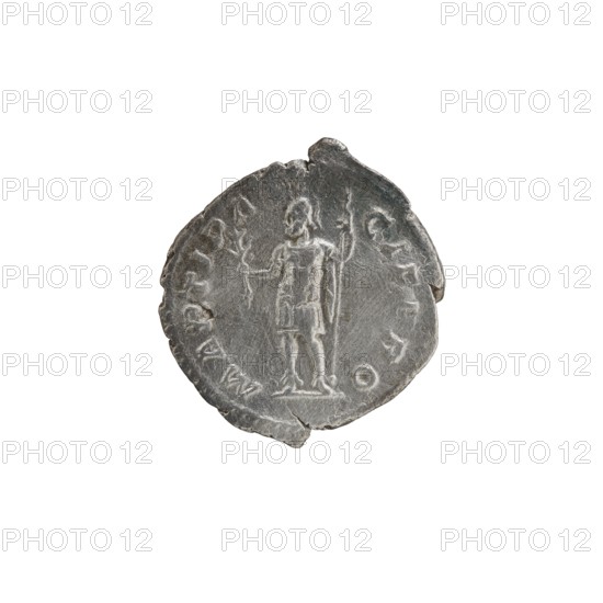 Denarius of Alexander Severus 208–235; Roman emperor 222–235. Obverse: Bust of Alexander Severus in laurel wreath, armor and paludamentum facing right; legend IMPCMAVRSEVALEXANDAVG; pearl border. Reverse: Mars in military dress and helmet standing left, holding a branch in his right hand and resting his left on a standing spear; legend MARTIPACIFERO; pearl border. Roman Empire, Rome, dated 222–228. Coin; diameter ca. 18.5–20.0 mm; weight 2.85 g., A round, worn metallic object with an uneven edge, showing a raised depiction of a standing human figure holding a staff in one hand and another object in the other, surrounded by faint decorative marks and shapes; the surface shows scratches and wear with variations in texture. Colors visible include shades of silver, gray, and darker gray tones.