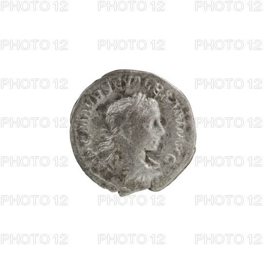 Denarius, Alexander Severus 208–235; Roman emperor 222–235. Obverse: IMPCMAVRSEVALEXANDAVG — Bust of Alexander Severus with laurel wreath and paludamentum facing right; pearl border. Reverse: MARTIPA CIFERO — Mars in military dress and helmet standing left, holding a branch in his right hand and leaning his left against a standing spear; pearl border. Roman Empire, 222–228. Coin; diameter 17.5–19.0 mm; weight 2.27 g., A circular metallic object with a worn surface showing the raised profile of a person facing right, with visible hair and neck details; the object has an uneven, slightly chipped edge and a textured surface. The visible colors are shades of gray and silver, with subtle darker gray areas indicating wear.