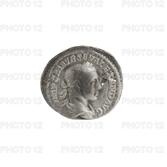 Denarius; personifications; Alexander Severus Roman emperor, 222–235 — iconography: Salus. Obverse: IMPCMAVRSEVALEXANDAVG — Bust of Alexander Severus with laurel wreath and paludamentum facing right, pearl rim. Reverse: SALVSP VBLICA — Salus seated facing left, holding a patera in her right hand feeding a snake coiled around an altar, left hand on the backrest, pearl rim. Date: 222–228. Roman Empire. Rome. Coin. Diameter 17.5–20.0 mm. Weight 2.38 g., A circular metallic object with a worn, uneven surface showing a raised profile of a person facing right, including facial features, ear, and stylized hair tied at the back; the rim has raised decorative elements and a noticeable crack near the right edge; visible colors include silver, gray, and darker gray areas from wear and patina.