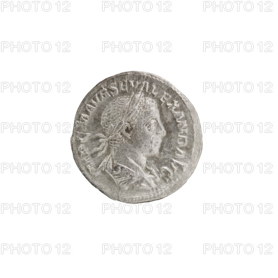 Denarius; Alexander Severus Roman emperor, 222–235. Obverse: Bust of Alexander Severus with laurel wreath and paludamentum facing right; legend IMPCMAVRSEVALEXANDAVG; pearl rim. Reverse: Jupiter naked in a cloak standing facing left, holding a thunderbolt in his right hand and a long scepter in his left; legend PM TR P II COS PP; pearl rim. Date: 223. Material: coin. Diameter: 18.5–19.0 mm. Weight: 2.22 g. Roman Empire., A circular metallic object with a worn silver-gray surface showing a raised profile of a person's head facing right, with short textured hair and a tied ribbon at the back; the outer edge features a ring of raised decorative marks; the background around the object is plain white.